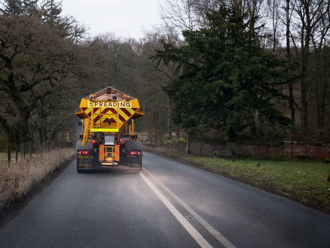 Environment - showing a gritting machine driving through countryside. As a gritting company, Nationwide Gritting cares about the environment.